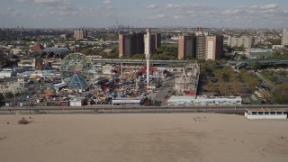 AX88_047 - 4K aerial stock footage flyby a roller coaster and Ferris wheel at Luna Park, Coney Island, Brooklyn, New York