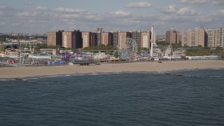 AX88_054 - 4K aerial stock footage tilt from Atlantic Ocean, reveal Luna Park and Coney Island Beach, Brooklyn, New York