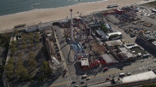 AX88_058 - 4K aerial stock footage of flying by Luna Park's beachfront rides in Coney Island, Brooklyn, New York, New York
