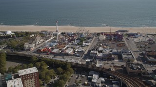 AX88_059 - 4K aerial stock footage of flying away from rides and beach at Luna Park, Coney Island, Brooklyn, New York