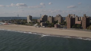 AX88_065 - 4K aerial stock footage of apartment buildings and Coney Island Beach in Brooklyn, New York