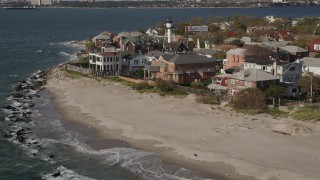 AX88_070 - 4K aerial stock footage of beachfront homes by the ocean in Coney Island, Brooklyn, New York, New York