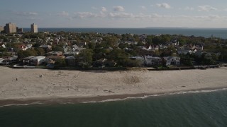 AX88_073 - 4K aerial stock footage of flying away from homes on the beach in Coney Island, Brooklyn, New York, New York