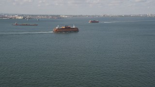 AX88_091 - 4K aerial stock footage of two Staten Island Ferries sailing New York Harbor, New York, New York