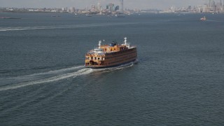 AX88_093 - 4K aerial stock footage of flying around a Staten Island Ferry sailing New York Harbor, New York, New York