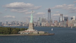 AX88_096 - 4K aerial stock footage approach Statue of Liberty, with Lower Manhattan skyline in background, New York