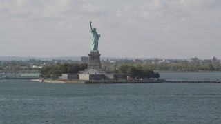 AX88_102 - 4K aerial stock footage tilt from New York Harbor, revealing Statue of Liberty, New York, New York