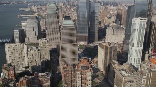 AX88_117 - 4K aerial stock footage of flying by World Trade Center Memorial and skyscrapers in Lower Manhattan, New York