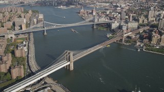 AX88_120 - 4K stock footage aerial video approach Brooklyn Bridge and Manhattan Bridge spanning East River, New York, New York