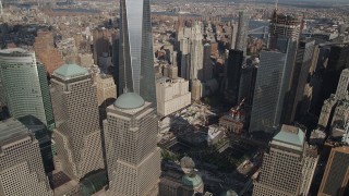 AX88_134 - 4K aerial stock footage tilt down One World Trade Center, reveal World Trade Center Memorial, New York