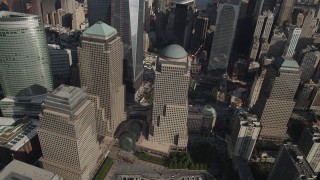 AX88_135 - 4K aerial stock footage of flying by skyscrapers by the World Trade Center Memorial, Lower Manhattan, New York