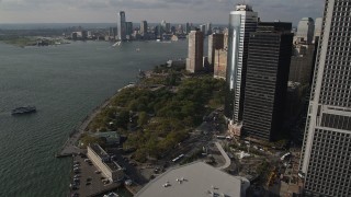 AX88_145 - 4K stock footage aerial video of approaching Battery Park by skyscrapers in Lower Manhattan, New York, New York