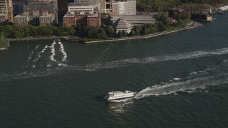 AX88_156 - 4K aerial stock footage of tracking a ferry on the Hudson River, Lower Manhattan, New York, New York