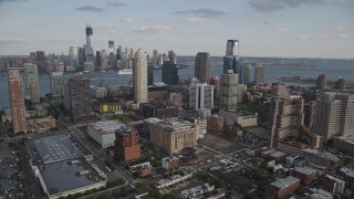 AX88_171 - 4K aerial stock footage of city skyscrapers and Lower Manhattan skyline in background, Downtown Jersey City, New Jersey