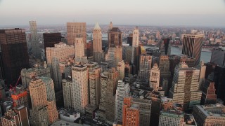 AX89_005 - 4K aerial stock footage Fly over Lower Manhattan, approach 40 Wall Street, New York, New York, sunset