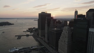 AX89_017 - 4K aerial stock footage Flying by Lower Manhattan, Staten Island Ferry, New York, New York, sunset