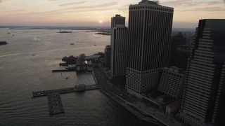 AX89_018 - 4K aerial stock footage Flying by Staten Island Ferry, New York Harbor, Lower Manhattan, New York, sunset