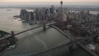 AX89_035 - 4K aerial stock footage of the Brooklyn Bridge, Manhattan Bridge, Lower Manhattan, New York, twilight