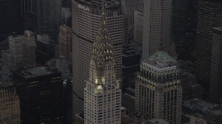 AX89_061 - Aerial stock footage of Flying by the Chrysler Building, Midtown Manhattan, New York, New York, twilight