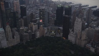 AX89_068 - 4K aerial stock footage Flying by Columbus Circle, Midtown Manhattan, New York, New York, twilight
