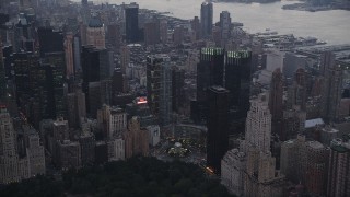 AX89_069 - 4K aerial stock footage Flying by Columbus Circle, revealing Times Square, New York, New York, twilight