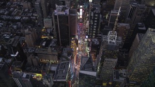 AX89_084 - 4K aerial stock footage Approaching Times Square, Midtown Manhattan, tilt down, New York, twilight
