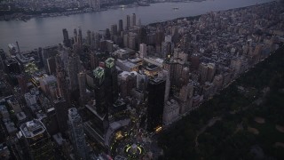 AX89_086 - 4K aerial stock footage Flying by skyscrapers, Columbus Circle, Upper West Side, New York, twilight