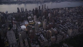 AX89_087 - 4K aerial stock footage Flying by skyscrapers, Upper West Side, New York, New York, twilight