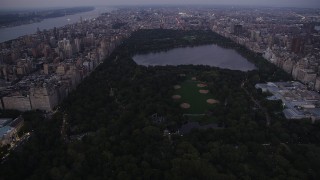 AX89_089 - 4K aerial stock footage Approaching Central Park, New York, New York, twilight
