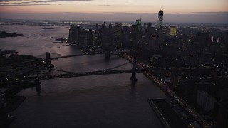 AX89_106 - 4K aerial stock footage of the Brooklyn Bridge, Manhattan Bridge, East River, Lower Manhattan, New York, twilight