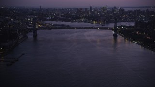 AX89_116 - 4K aerial stock footage Approaching the Williamsburg Bridge, East River, New York, New York, twilight