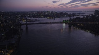 AX89_117 - 4K aerial stock footage Approaching Williamsburg Bridge, East River, New York, New York, twilight