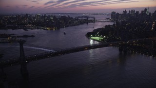 AX89_118 - 4K aerial stock footage Flying by Williamsburg Bridge, tilt down, New York, New York, twilight