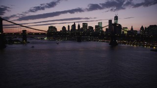 AX89_127 - 4K aerial stock footage Flying by Manhattan Bridge, Lower Manhattan skyline, New York, twilight