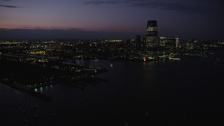 AX89_136 - 4K aerial stock footage Panning right to Goldman Sachs Tower, Downtown, Jersey City, New Jersey, twilight