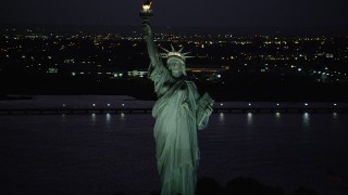 AX89_140 - 4K aerial stock footage Flying by Statue of Liberty, Liberty Island, New York, New York, night