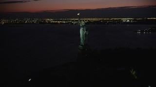 AX89_146 - 4K aerial stock footage Flying by Statue of Liberty, Liberty Island, New York, New York, night
