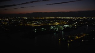 AX89_149 - 4K aerial stock footage Approaching parking garage, tilt down, Jersey City, New Jersey, night