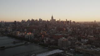 AX90_025 - 4K aerial stock footage Flying by Hudson River Park, revealing Midtown Manhattan, New York, sunrise