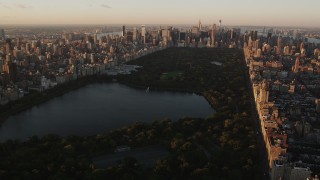 AX90_039 - 4K aerial stock footage Flying over Central Park, approaching Midtown, New York, New York, sunrise