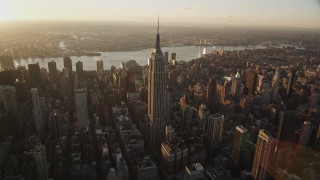 AX90_049 - 4K aerial stock footage Flying by Empire State Building, Midtown Manhattan, New York, sunrise