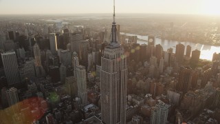 AX90_051 - 4K aerial stock footage Flying by the Empire State Building, Midtown Manhattan, New York, sunrise