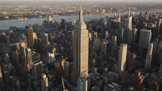 AX90_053 - 4K aerial stock footage Flying by the Empire State Building, Midtown Manhattan, New York, sunrise