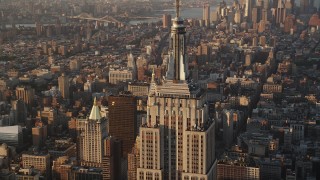 AX90_060 - 4K aerial stock footage Flying by Empire State Building, Midtown Manhattan, New York, sunrise