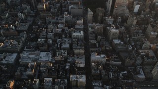 AX90_067 - 4K aerial stock footage of 5th Avenue, reveal Empire State Building, Midtown Manhattan, New York, sunrise