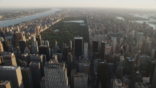 AX90_075 - 4K aerial stock footage Approaching Central Park, seen from Midtown Manhattan, New York, sunrise