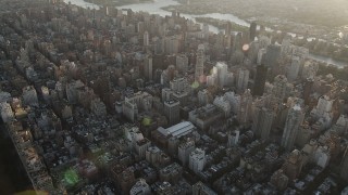 AX90_079 - 4K aerial stock footage Panning left across Upper East Side, reveal Central Park, New York, New York, sunrise