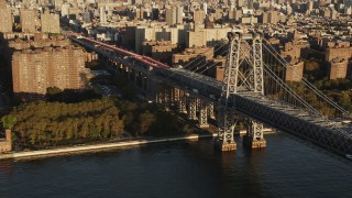 AX90_097 - 4K aerial stock footage Tracking light traffic over the Williamsburg Bridge, New York, New York, sunrise