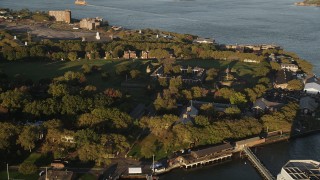 AX90_108 - 4K aerial stock footage Flying by Fort Jay, Governors Island, New York Harbor, New York, sunrise