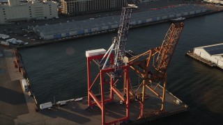 AX90_110 - 4K aerial stock footage Flying by cargo cranes, Brooklyn Cruise Terminal, Brooklyn, New York, sunrise